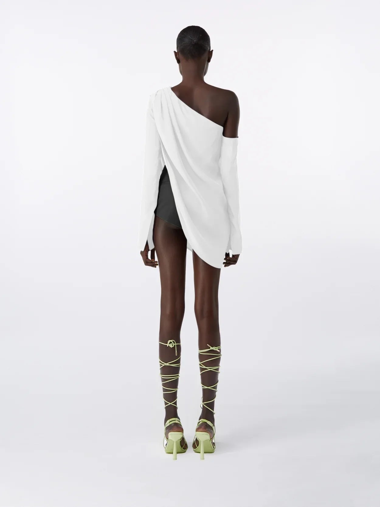 model wearing a white asymmetric long sleeve silk top