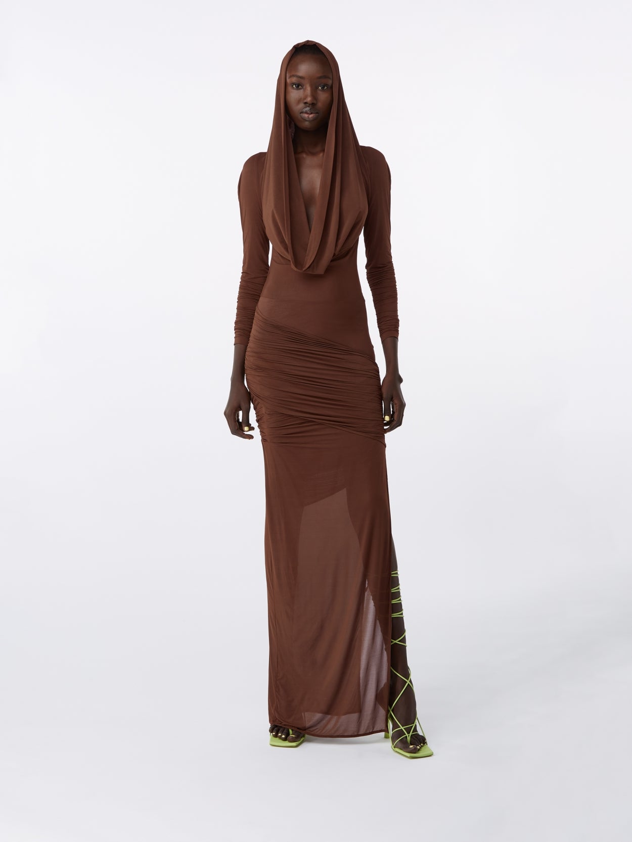 model wearing a brown hooded jersey draped dress