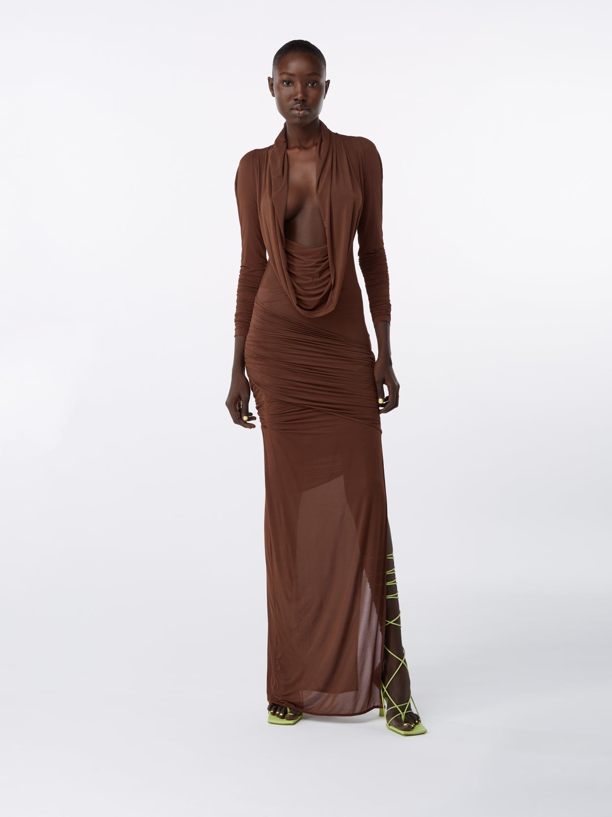 model wearing a brown hooded jersey draped dress 